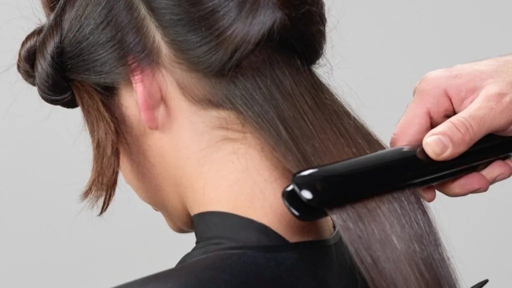 Model’s hair is flat ironed smooth.