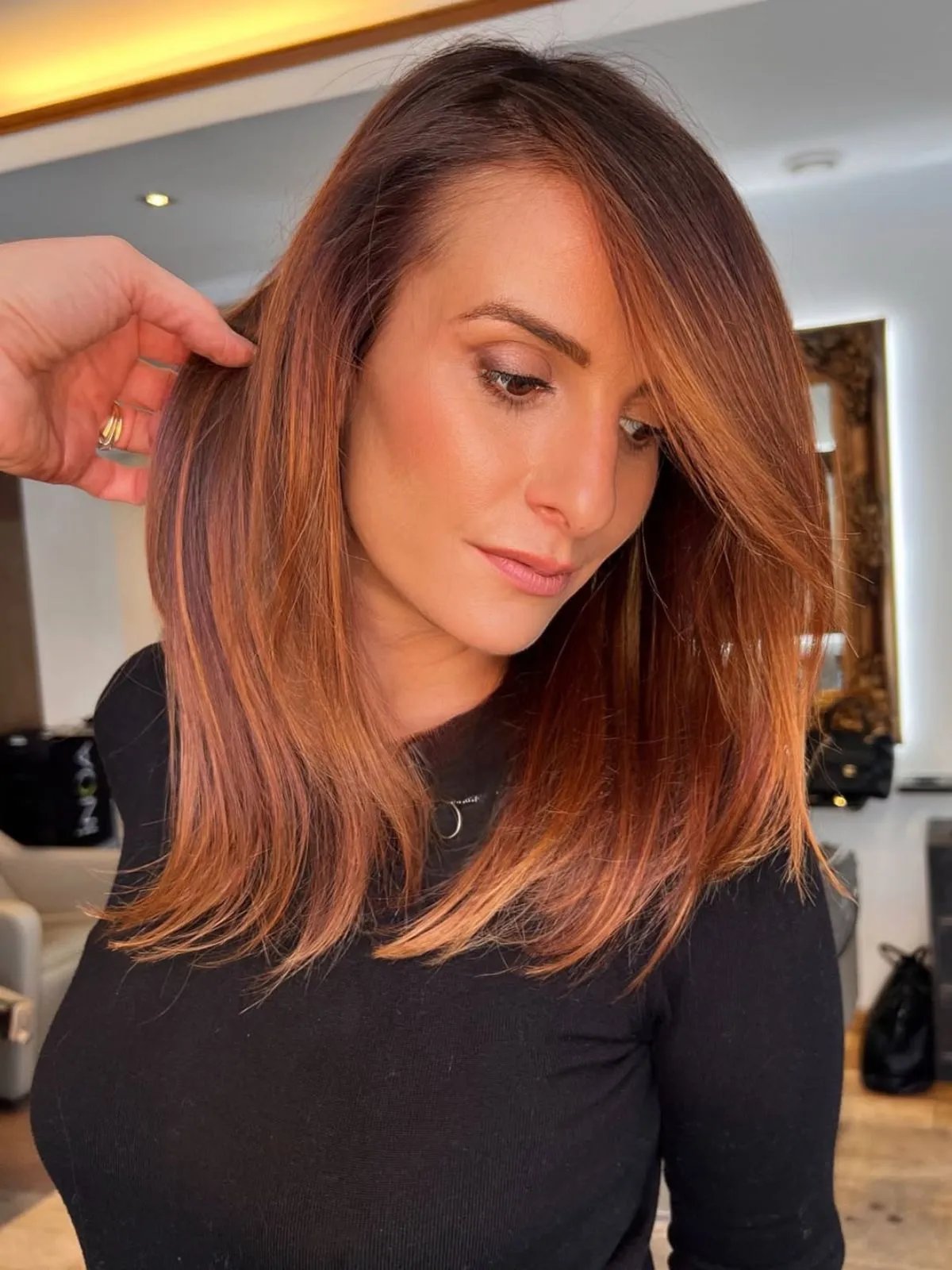Model with medium brown hair and copper auburn tones applied with an ombre technique.