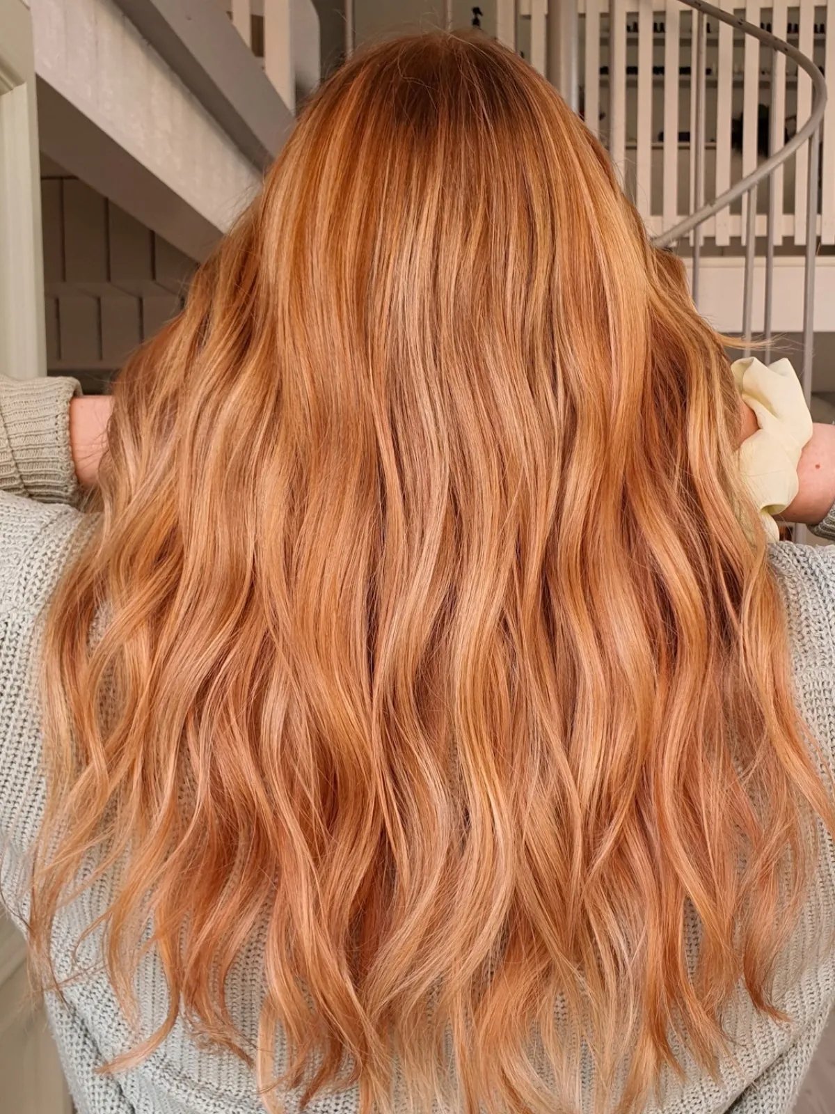 Model with long, loosely tousled, golden strawberry blonde hair.