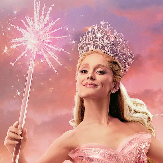 Ariana Grande appears as Glinda, holding a magic wand and wearing a silver crown.