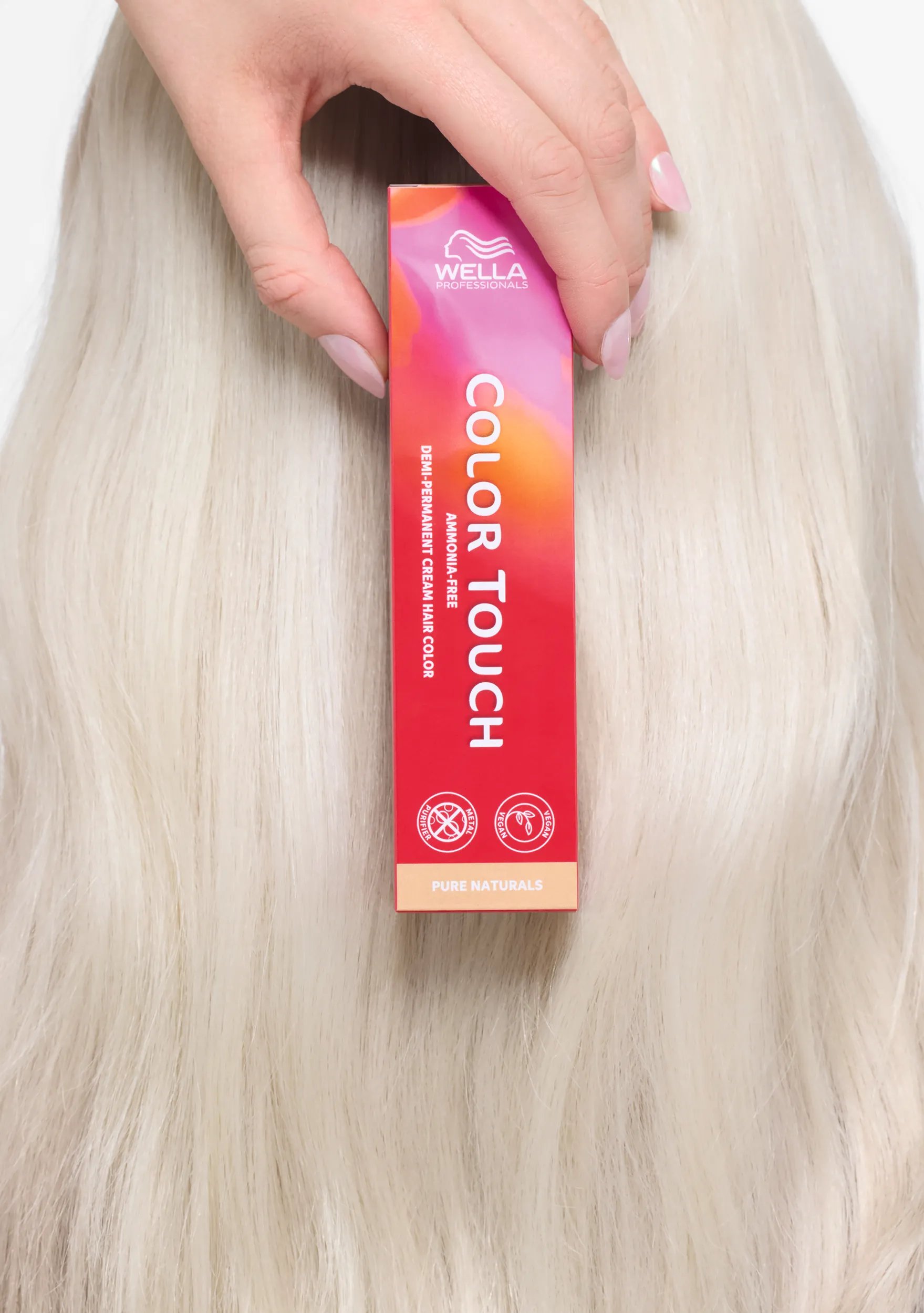 Back of model’s head. They hold a box of Color Touch by Wella Professionals over their long, brown hair