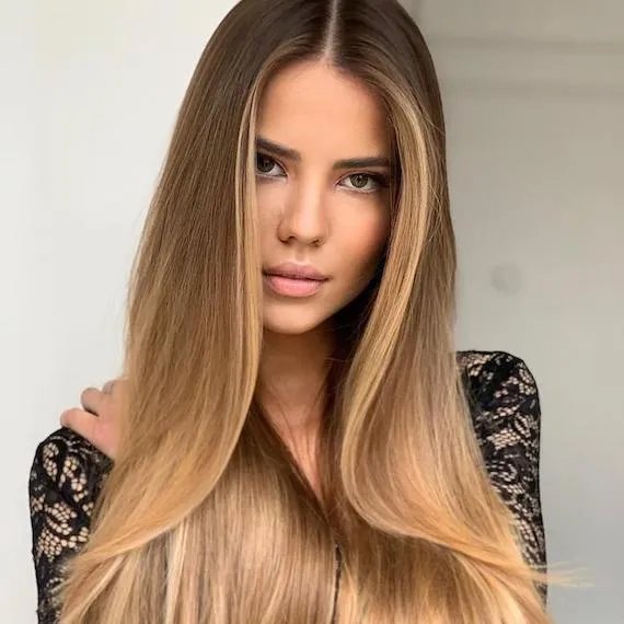 Model with long  hair and blonde balayage, created using Wella Professionals. 