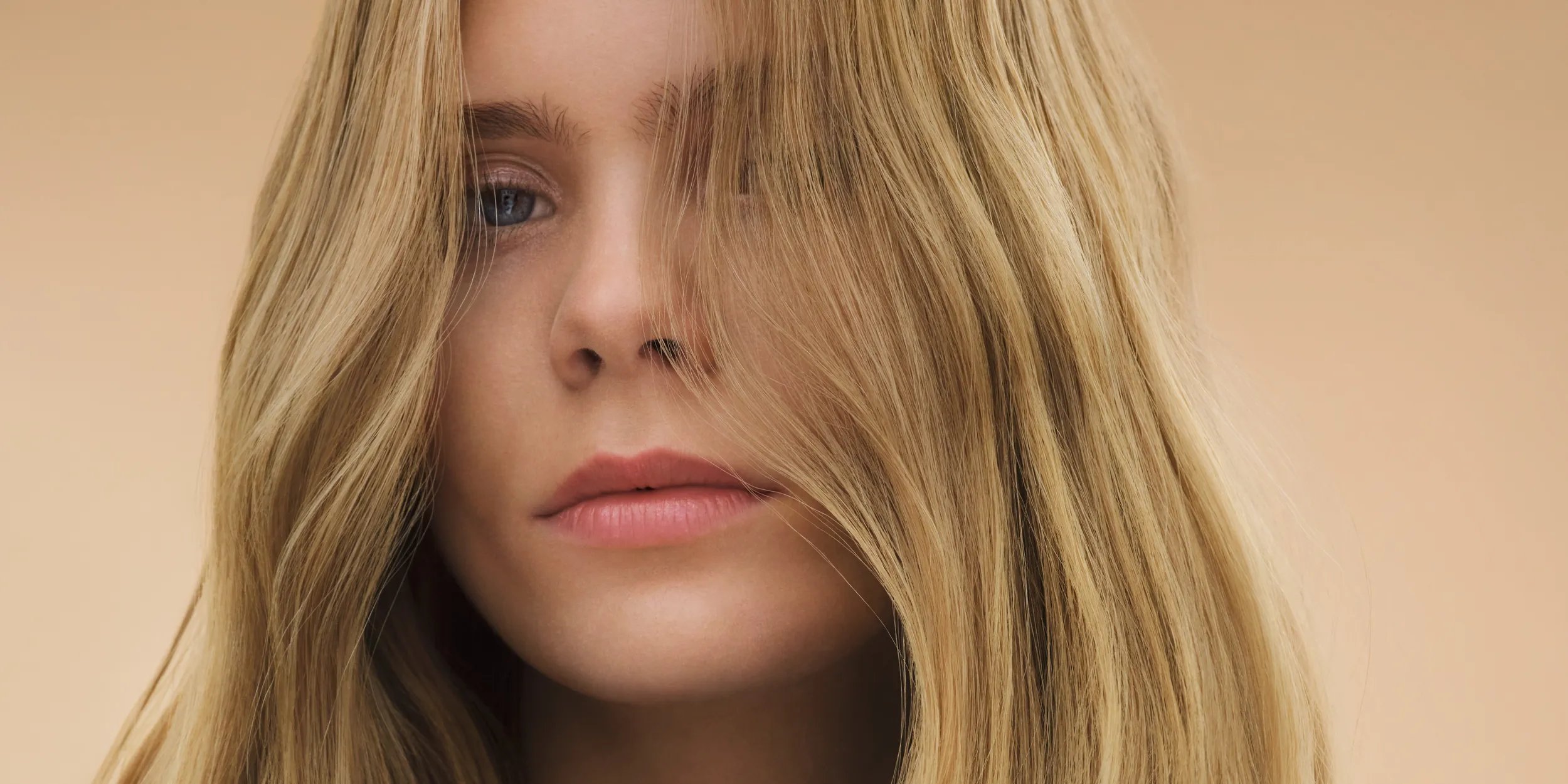 Model with full, voluminous, dark brown, silky-smooth hair.