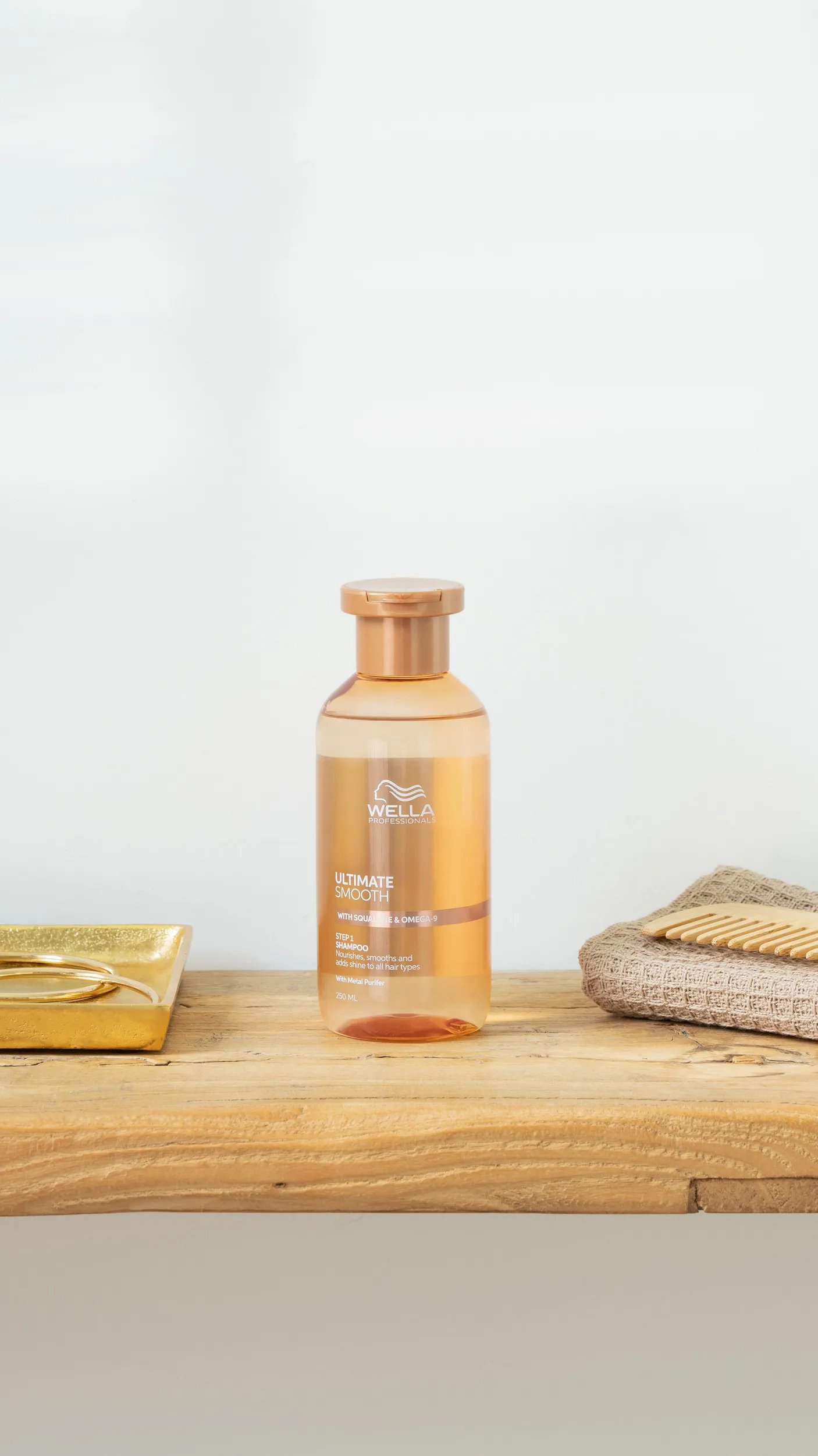 Bottle of ULTIMATE SMOOTH Shampoo on a wooden surface.