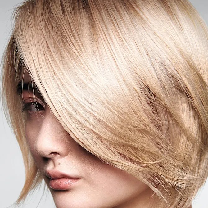 Close-up of model with buttery blonde bob haircut.