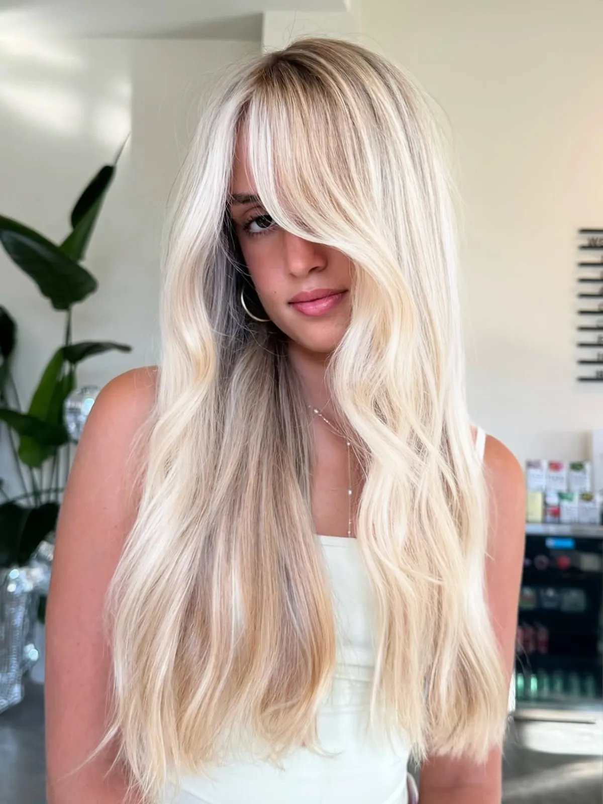 Color Fresh Mask in Pearl Blonde in front of a close-up of cool blonde hair.