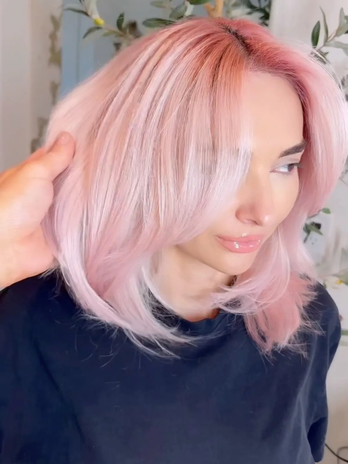 Model with pink-tinted platinum hair.