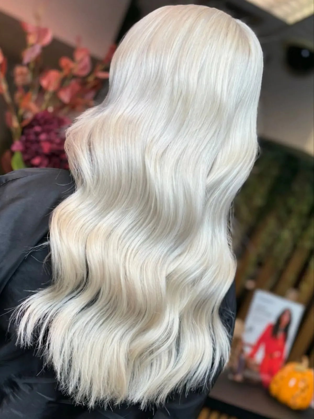Back of model’s head with long, loosely waved, pearl blonde hair.