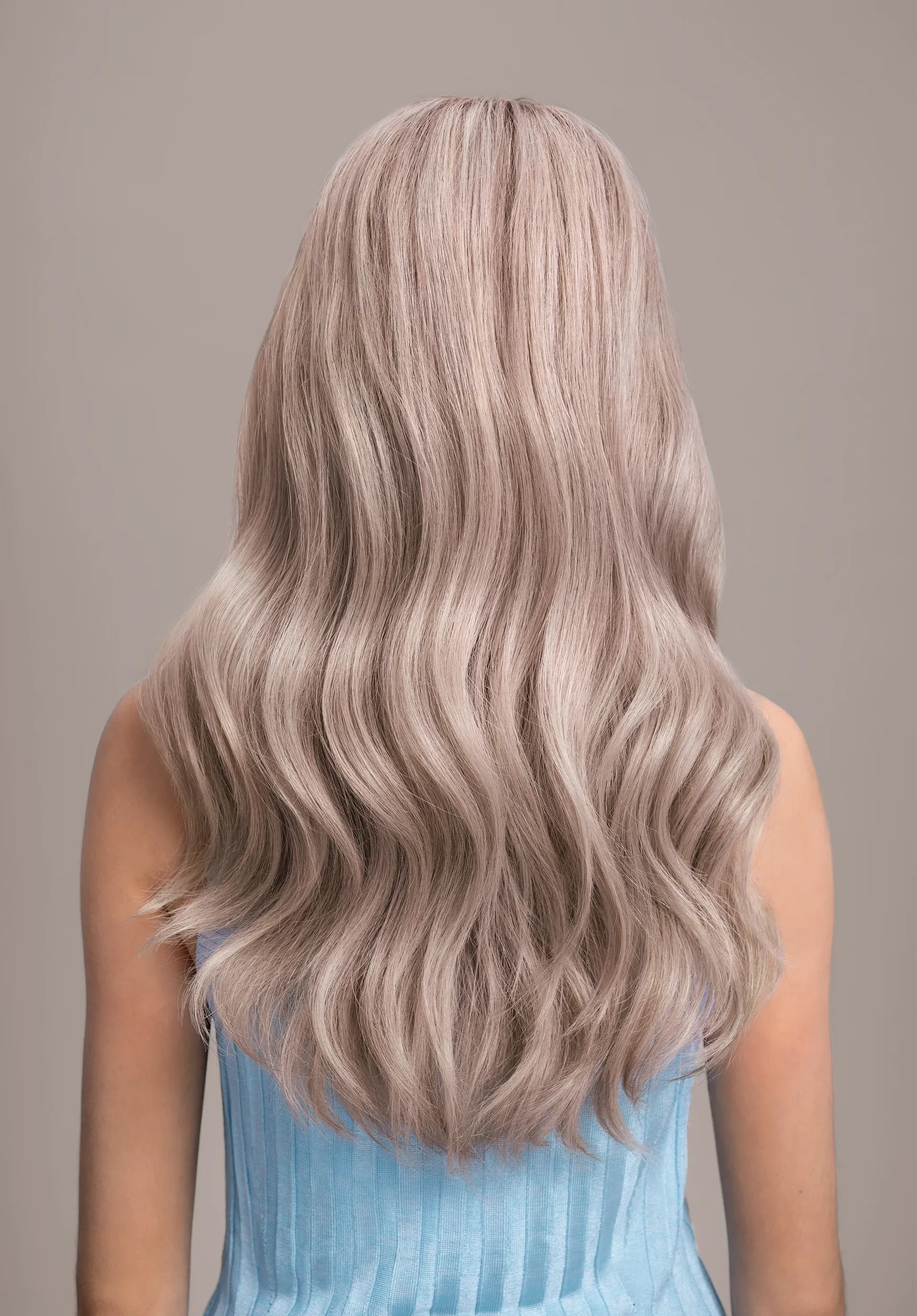 Back view of woman with long pearl blonde toned hair colored with Wella Color Fresh Mask.