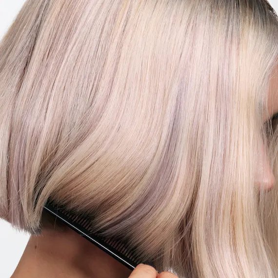 Close-up of model’s platinum blonde bob haircut.