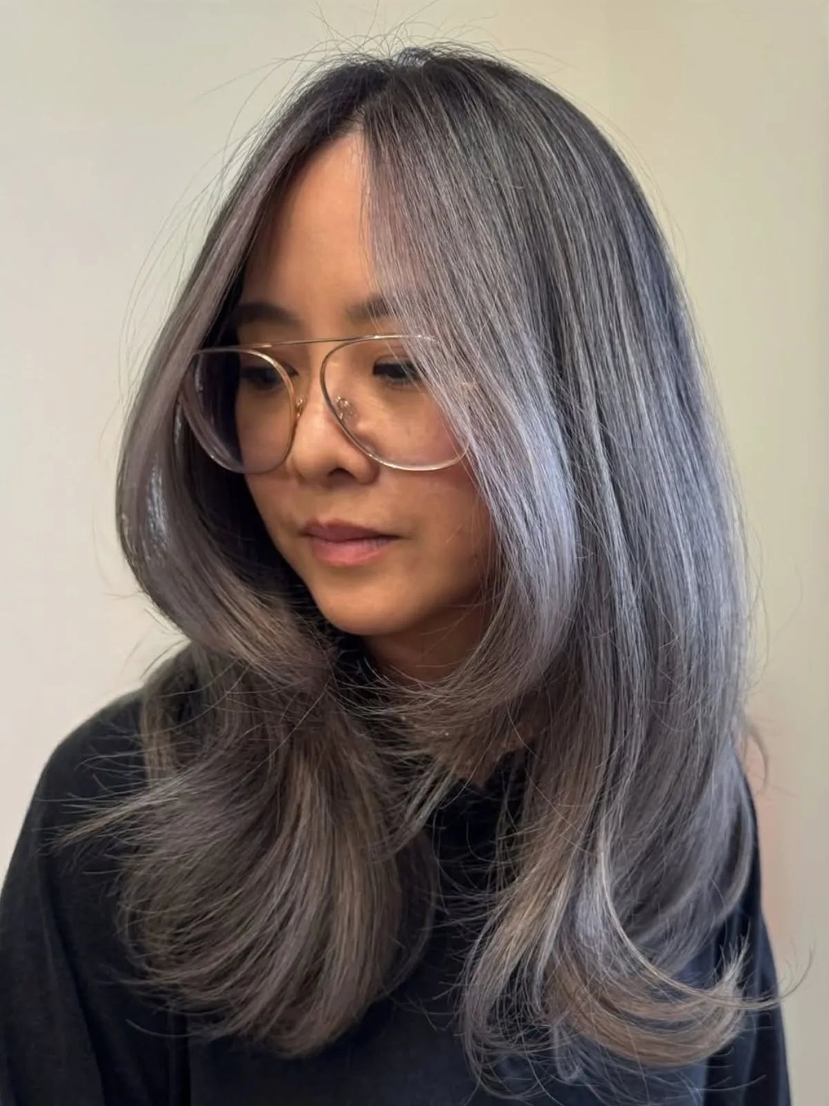 Model with dark hair featuring silvery grey highlights.