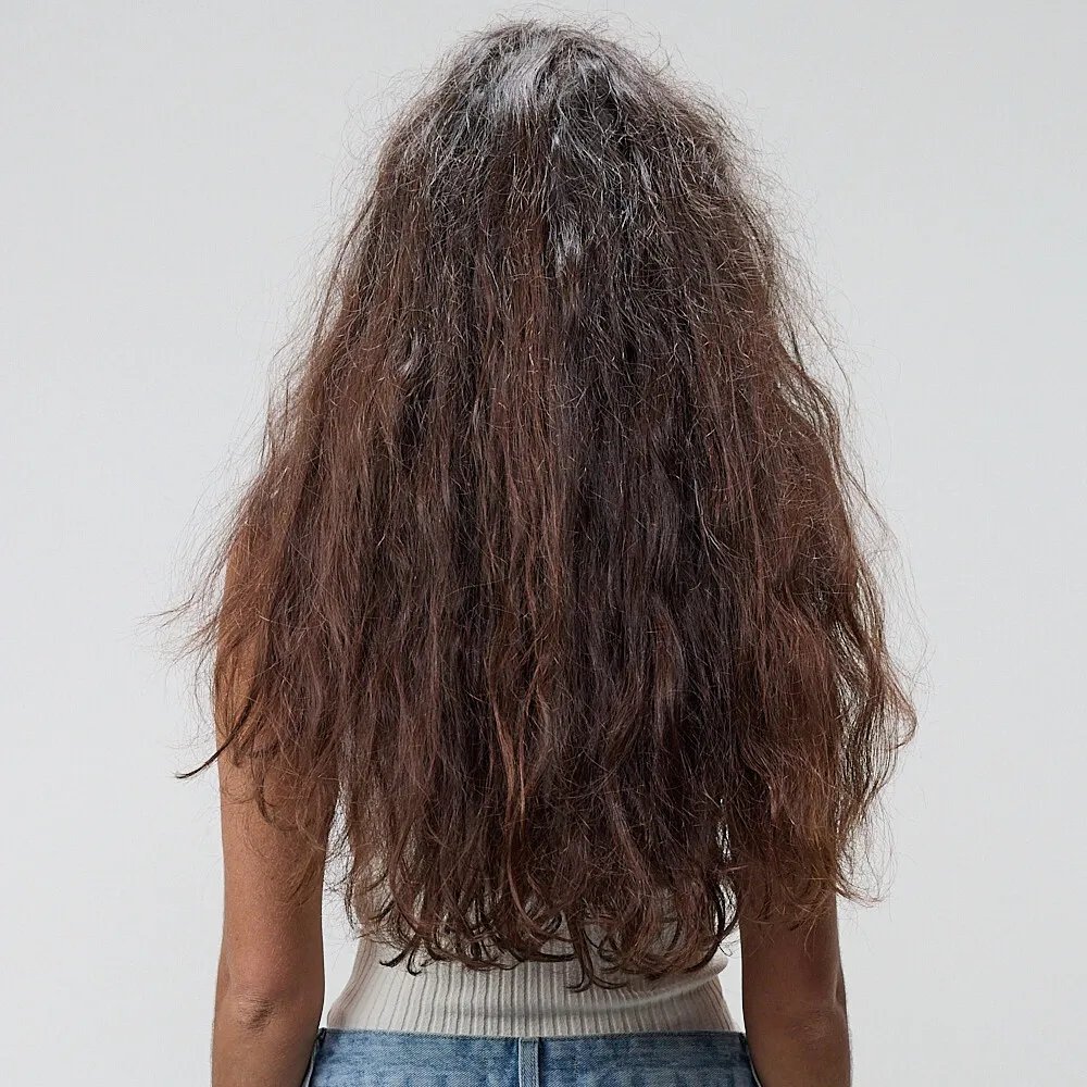 Before and after showing model’s long, brown, frizzy hair looking smooth and glossy after a SmoothFiller service.