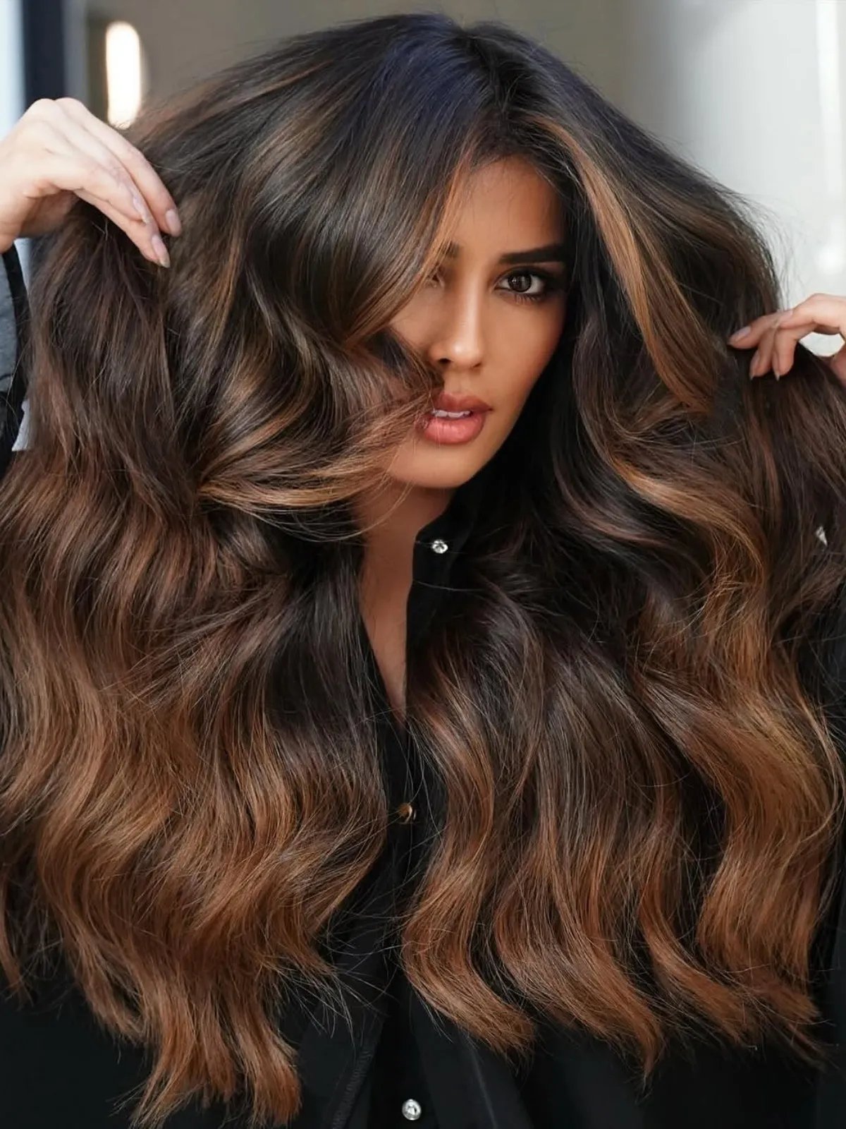 Model with mocha brown balayage blending caramel and bronze tones in a hand-painted, sunlit finish.