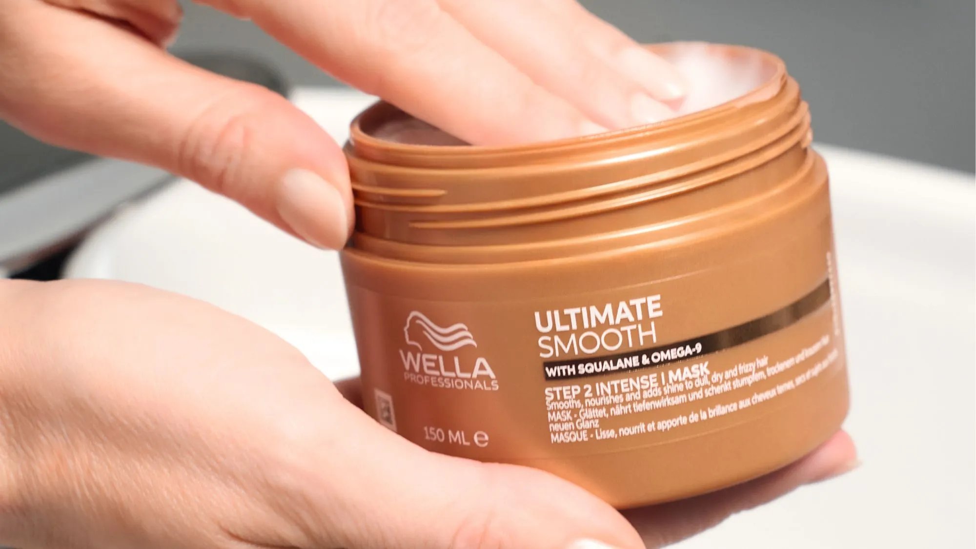 Hand reaches into a jar of ULTIMATE SMOOTH Intense Mask.
