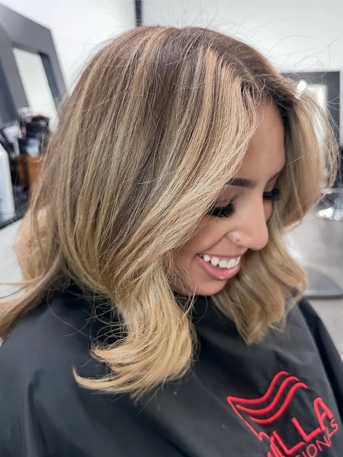 Model with brown hair featuring butterscotch blonde, chunky highlights. 