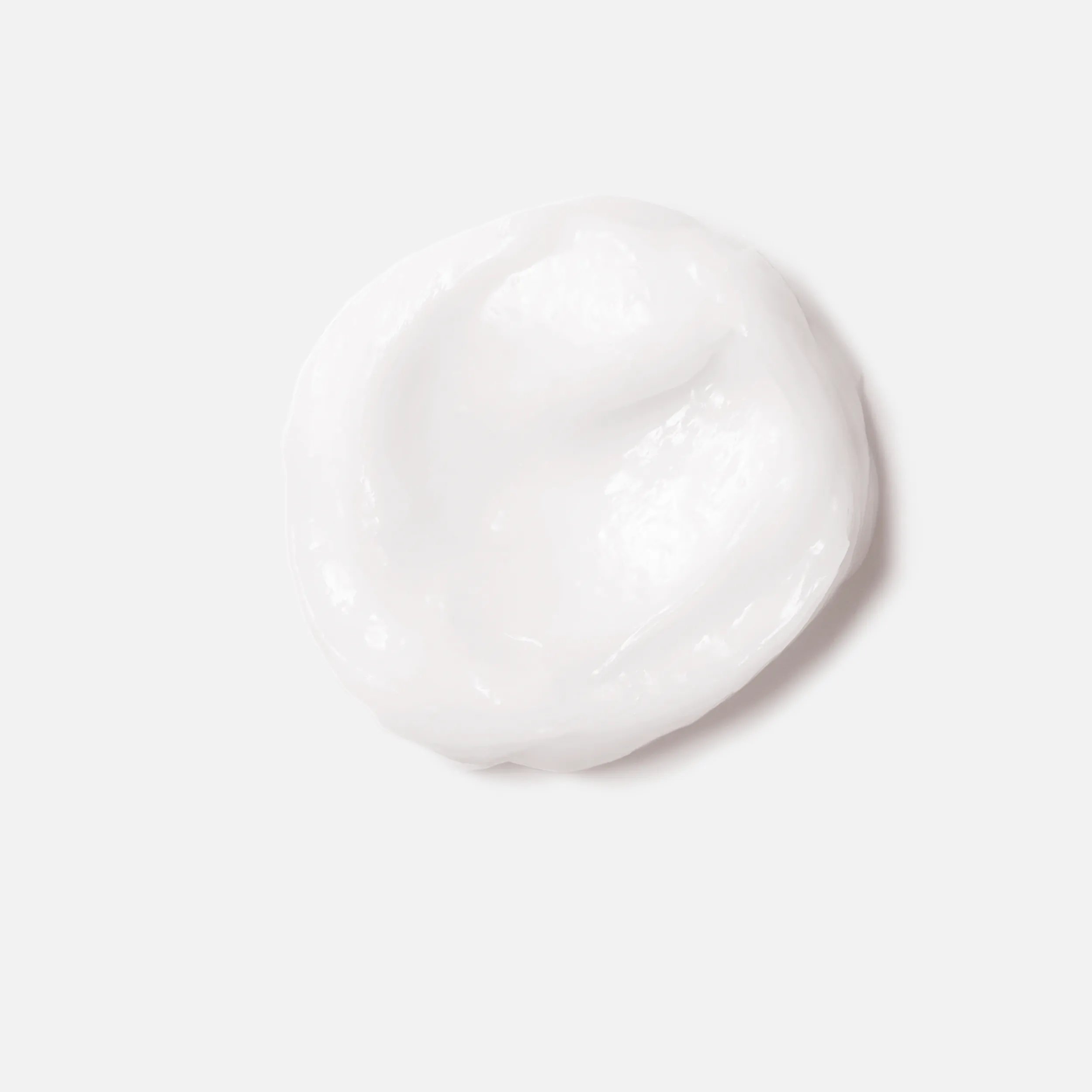 Close-up photograph of a circular blob of Fusion Intense Repair Mask product on a white background.