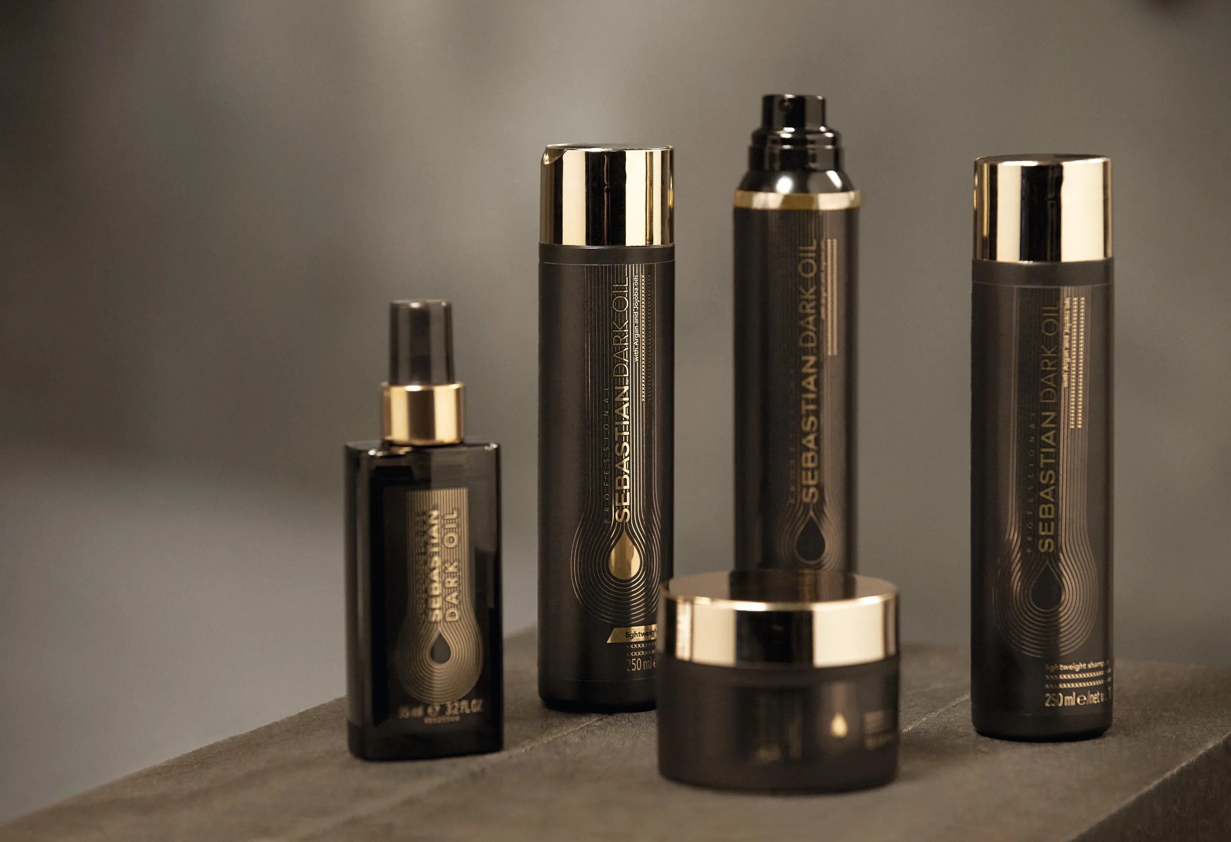 Product shot of Sebastian Dark Oil Lightweight range against neutral background. 