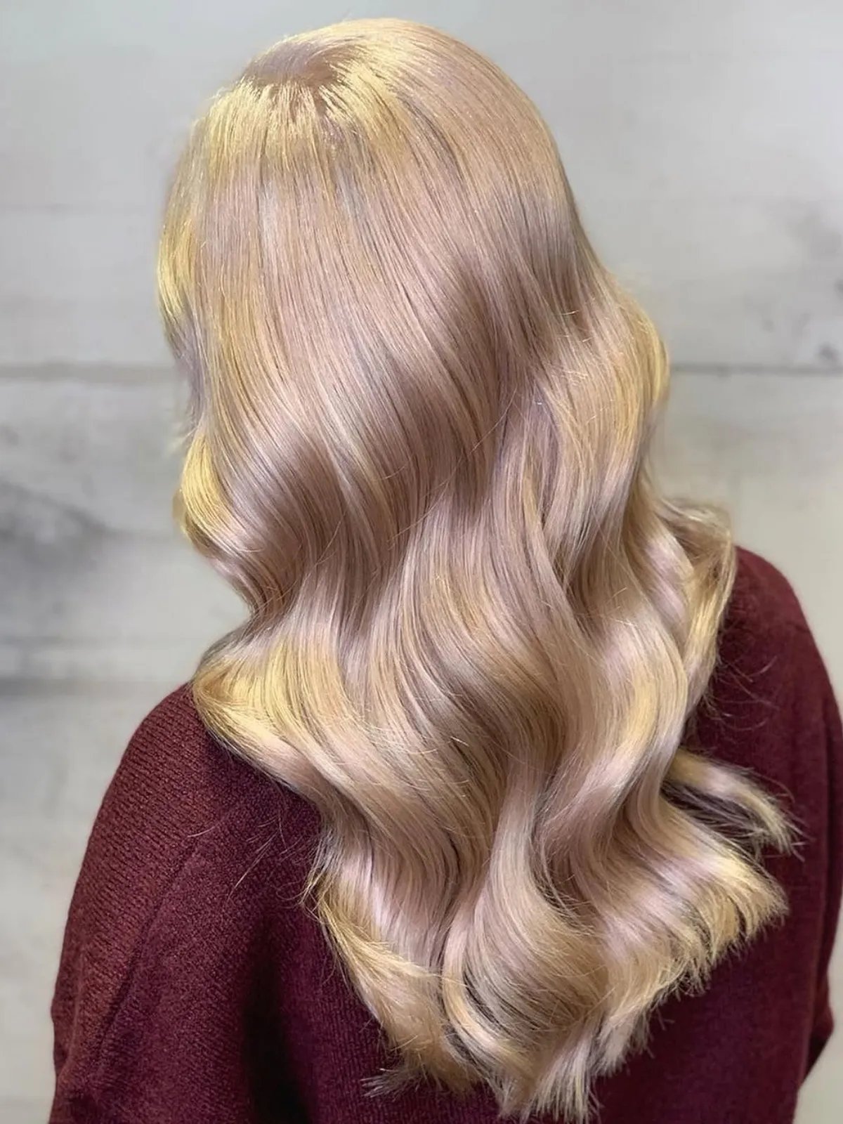  Model with long, loosely curled, champagne blonde hair.