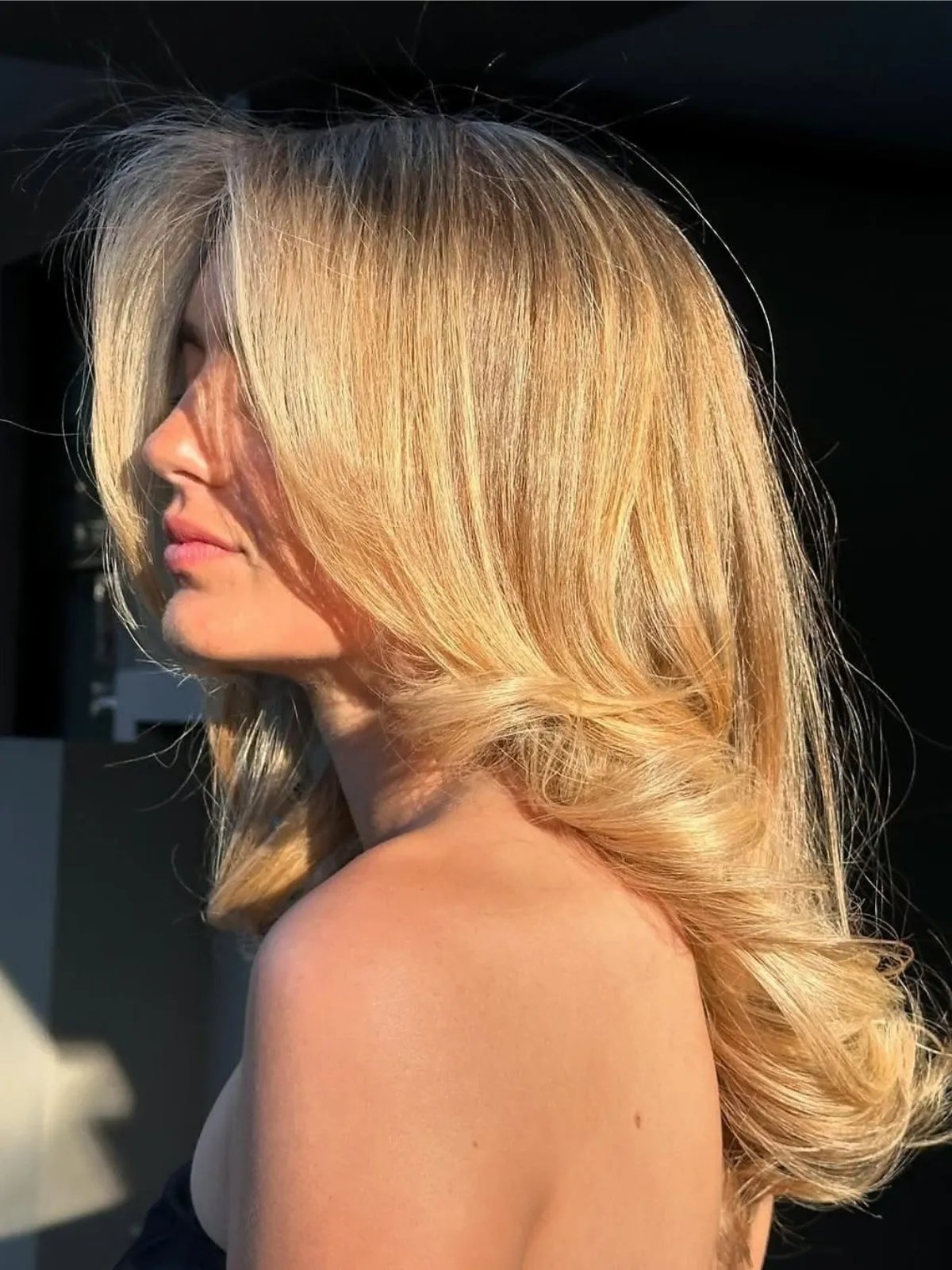 Model with bouncy blow-dried, golden blonde hair.