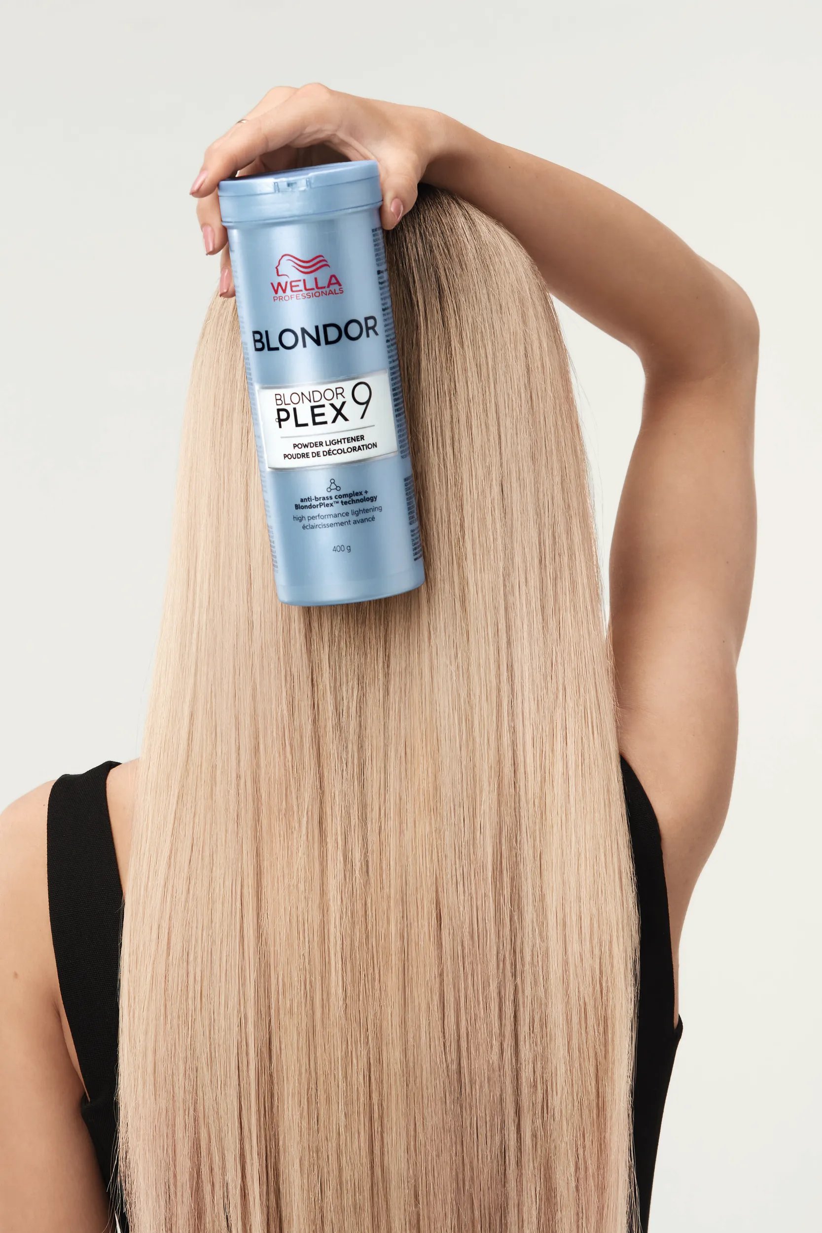 Woman with long blond hair holding a pack of Blondor