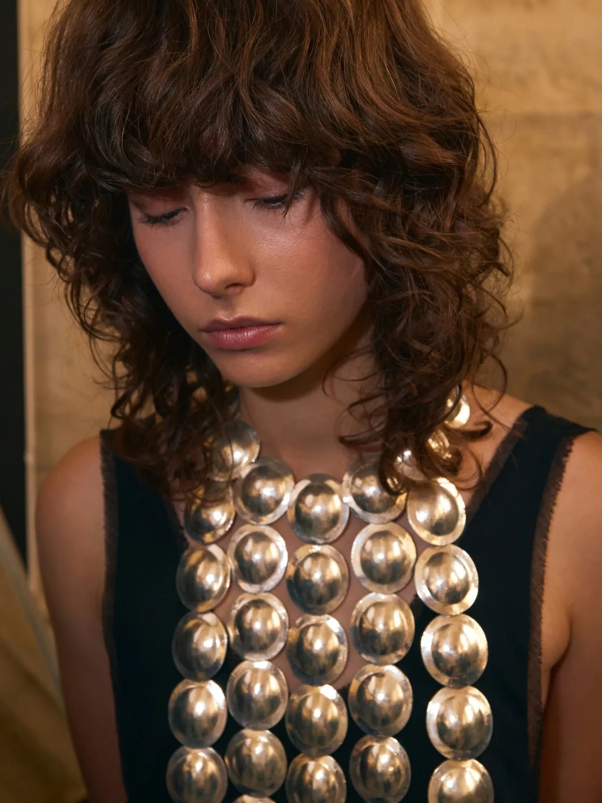 Model with a dark brown shag haircut.