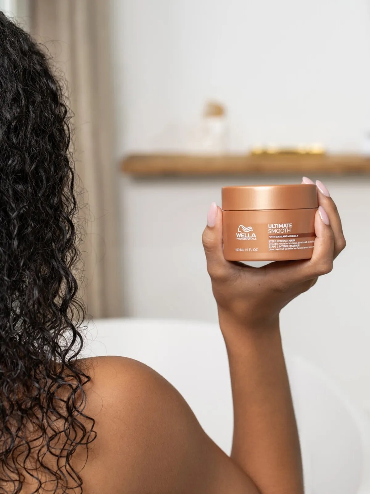 Model holds up ULTIMATE SMOOTH Intense Mask.