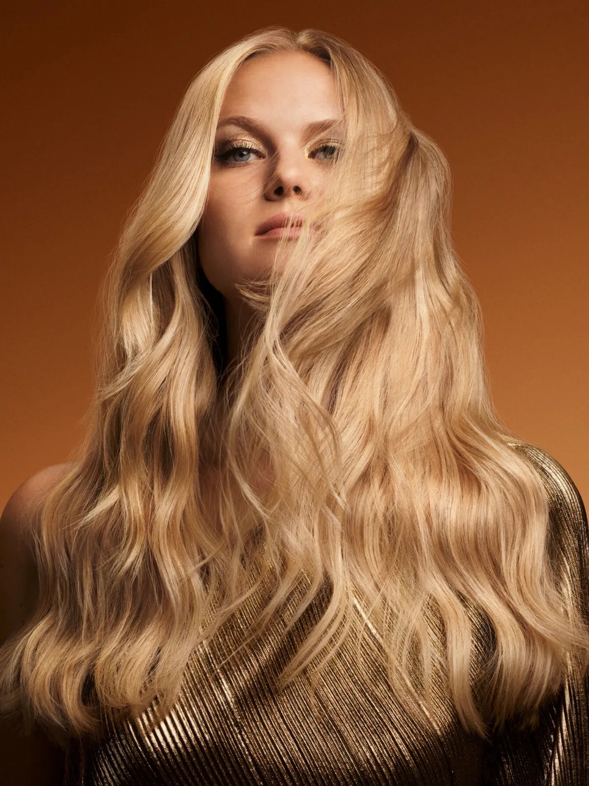 Model with long, wavy, glossy blonde hair.