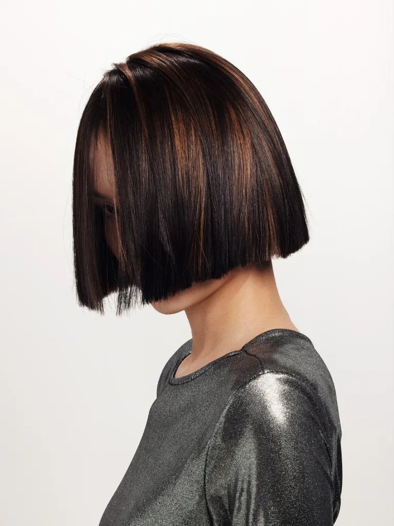 Close-up model’s chocolate brown and caramel hair color.