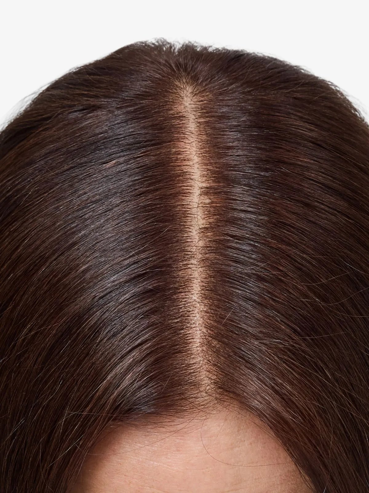 Brown-haired model’s grey roots completely covered with Koleston Xpress.