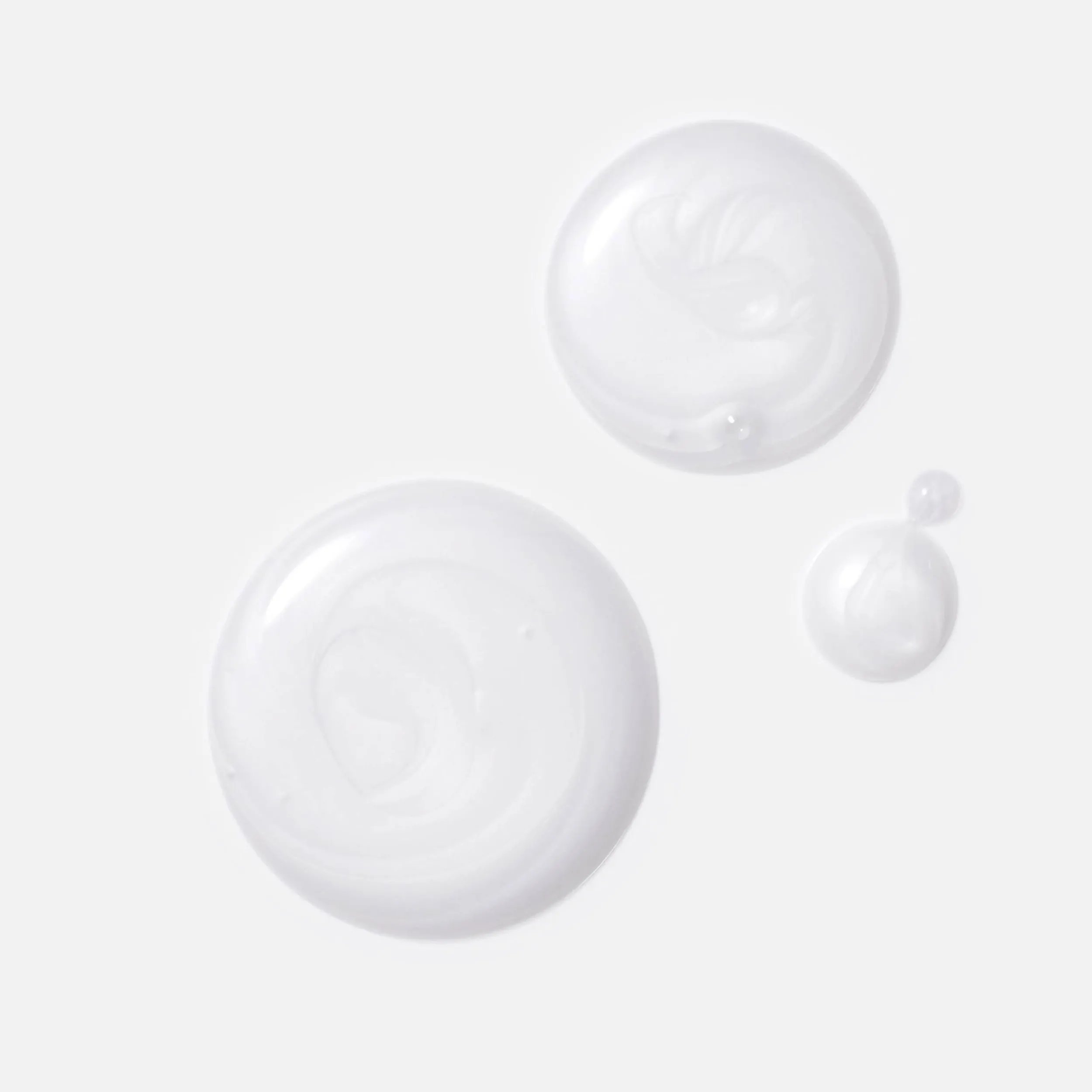 Image showcasing three dollops of white cream highlighting key ingredients: Oleic Acid & Panthenol for moisturization, and a Metal Purifier to protect from harmful metals in water.