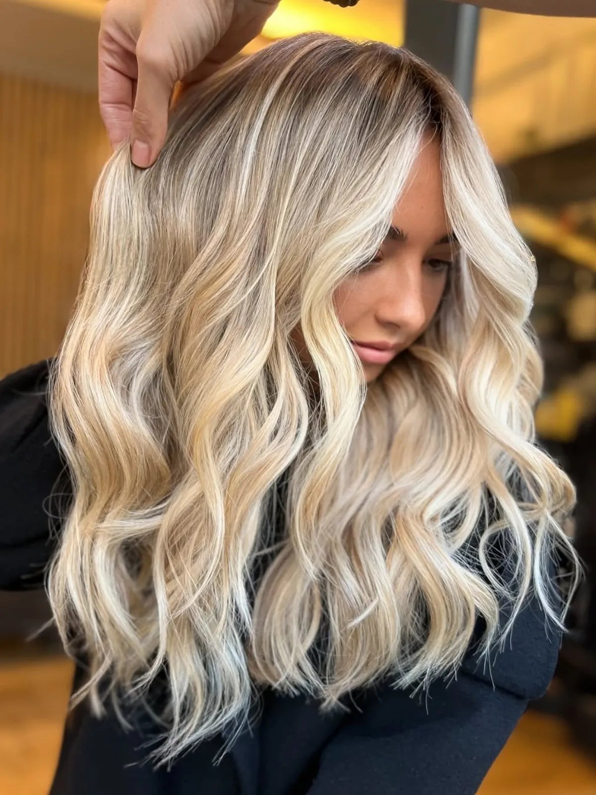 Model with beachy, tousled, champagne blonde hair.