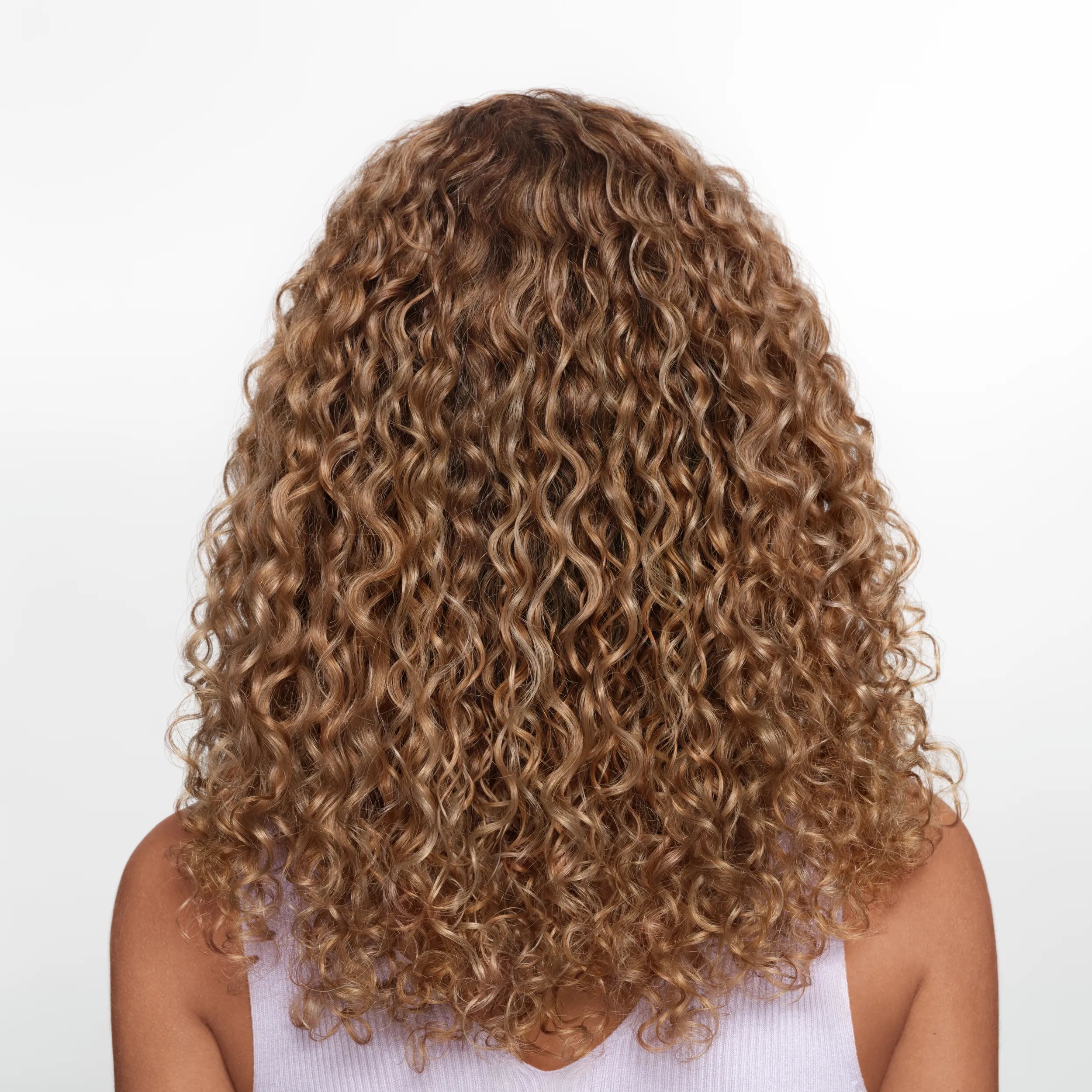 Image of the back of a model's head against a white background. Hair is short, red and straight. 	