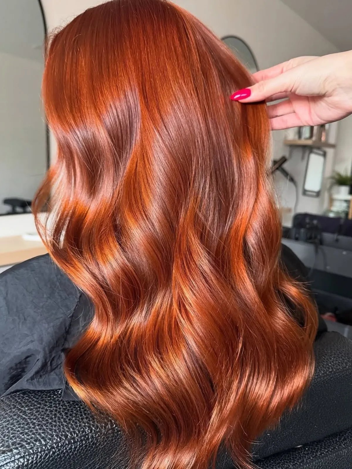 Model with ultra-glossy, bright cinnamon spice hair. 