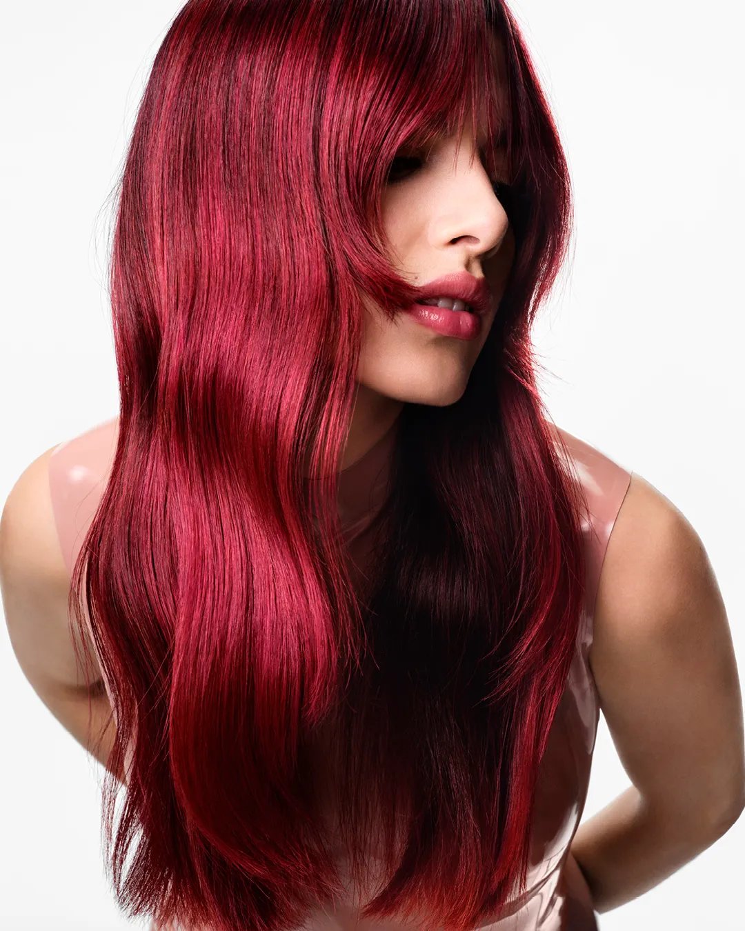 Model with long, loosely tousled, cherry red hair.