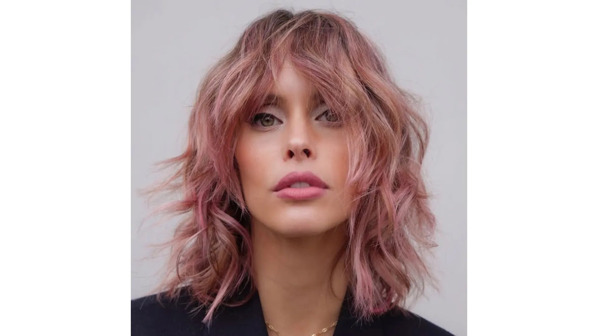 Model with a shag haircut in a dusty pink shade.