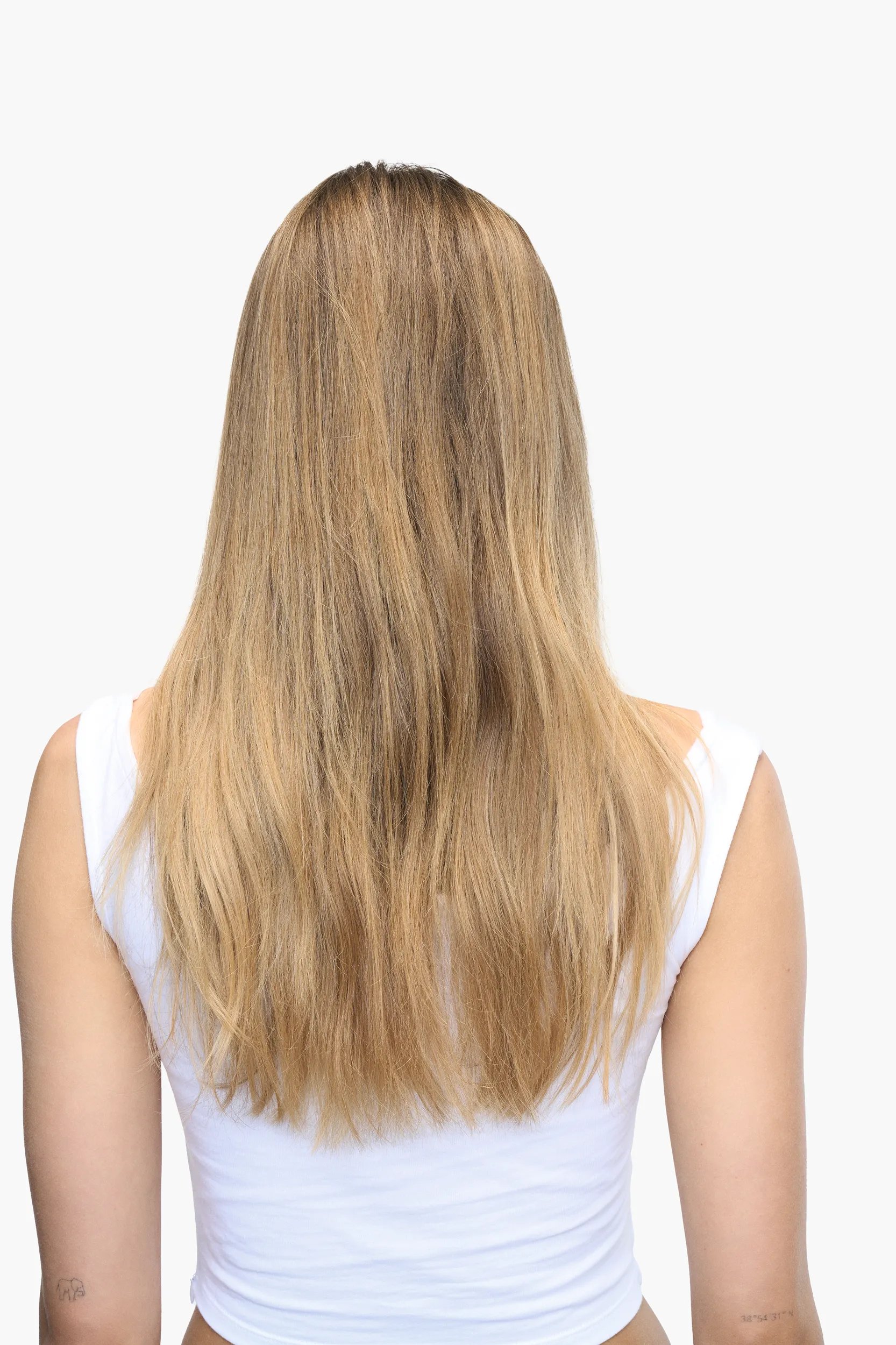 Model with short blonde bob faces away from the camera. Hair looks brassy and dull.