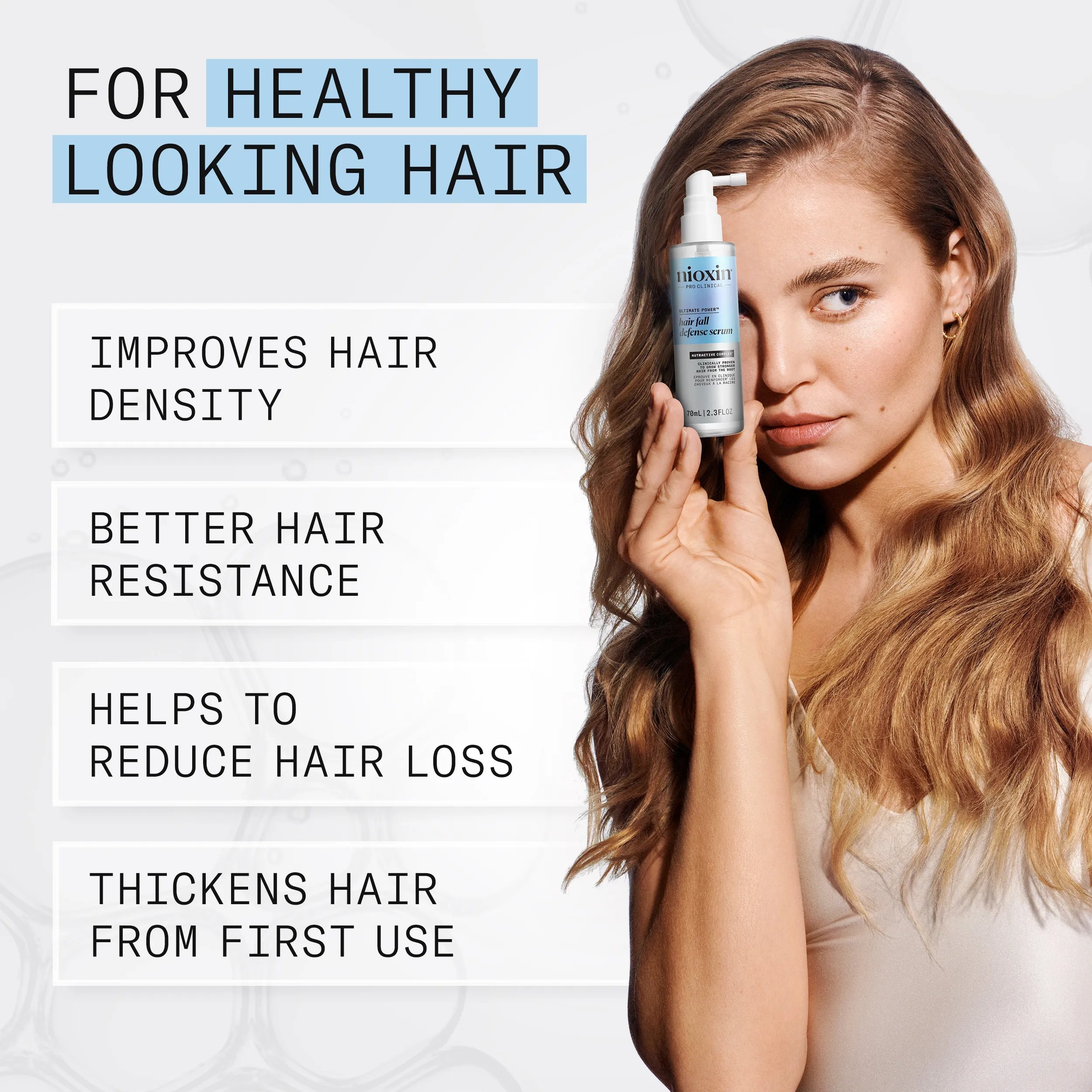 model holding Hair Fall Defense Serum 