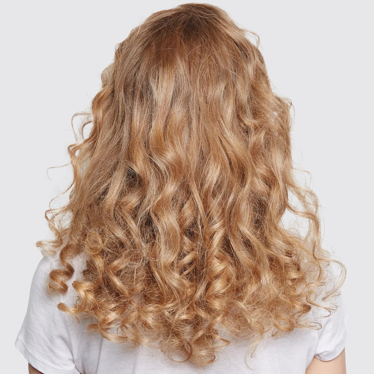 Image of healthy, curly, peachy blonde hair after using Wella Color Motion+ shampoo.