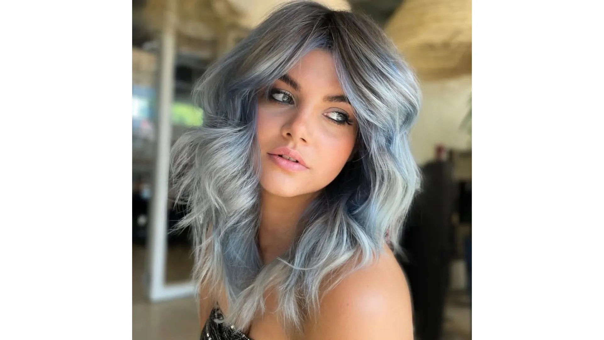 Model with beachy, wavy hair in shades of teal green and ocean blue.