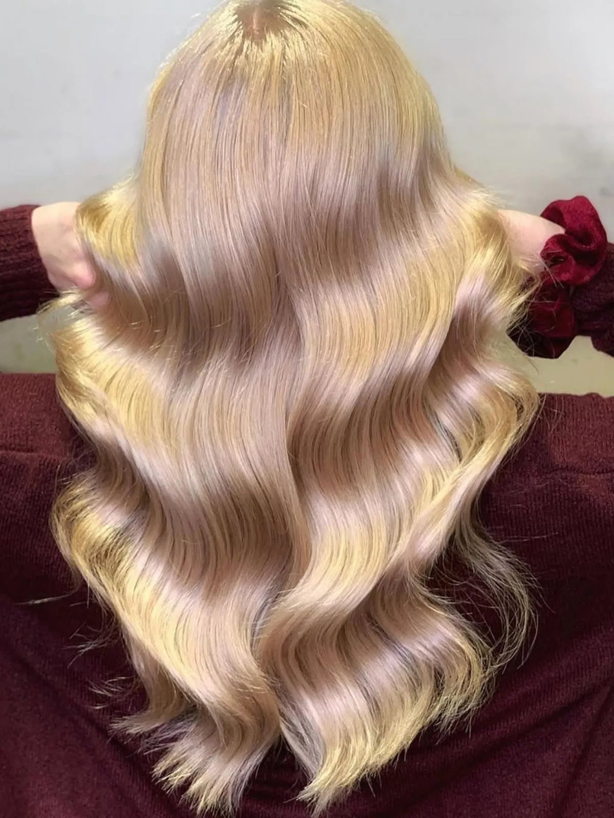 Model with long, loosely curled, champagne blonde hair.