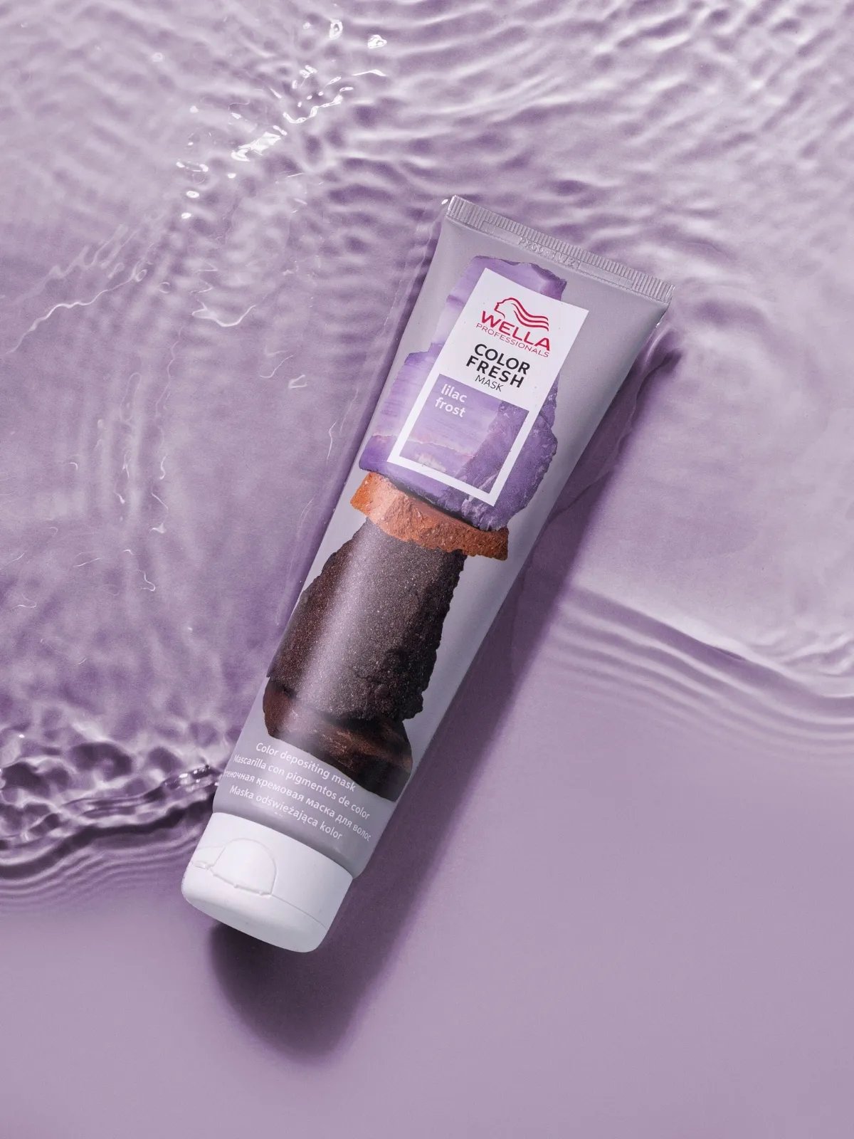 Color Fresh Mask in Lilac Frost floating in a pool of lilac water.