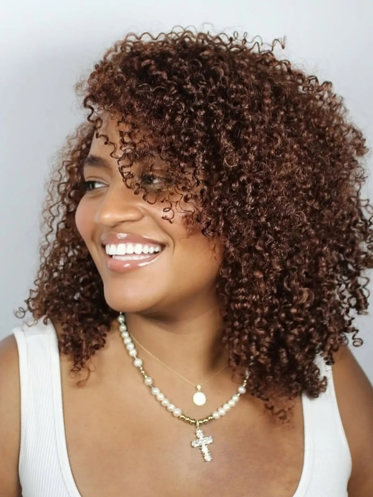 Chocolate cherry hair color with a blend of red and brown tones for a warm, rich look.