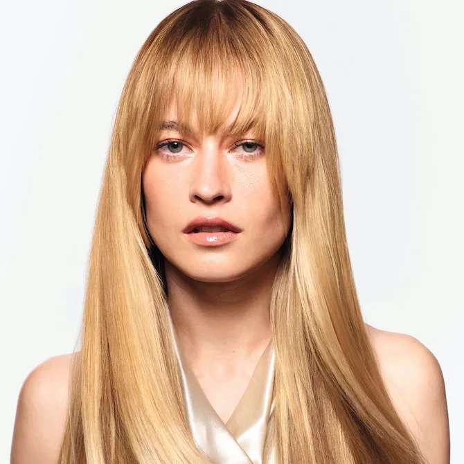 Model with long, straight, honey blonde hair and glass-like shine.
