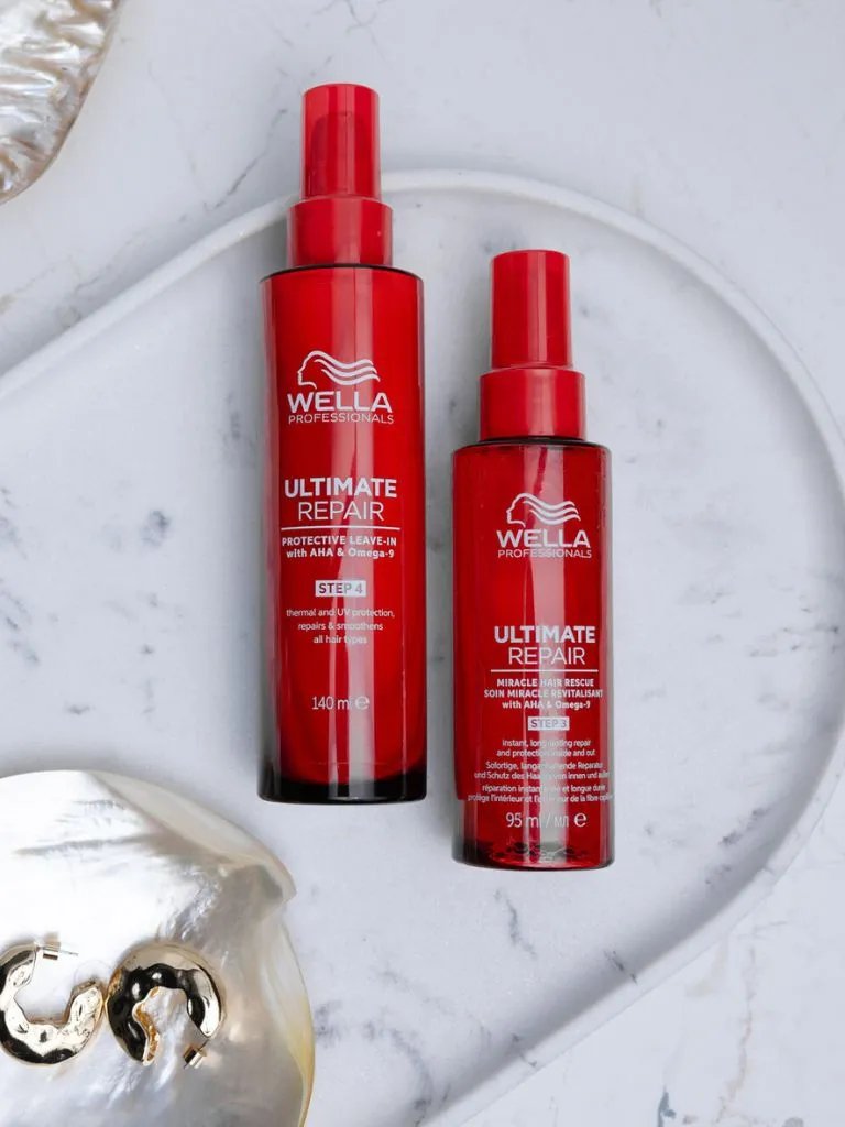 ULTIMATE REPAIR Protective Leave-In and Miracle Hair Rescue on a marble surface.