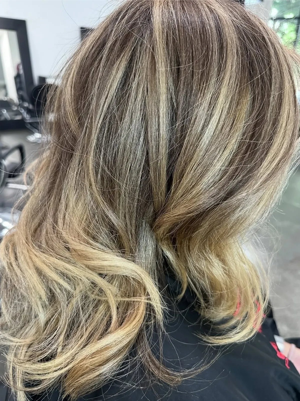 Model with brown hair featuring butterscotch blonde, chunky highlights. 