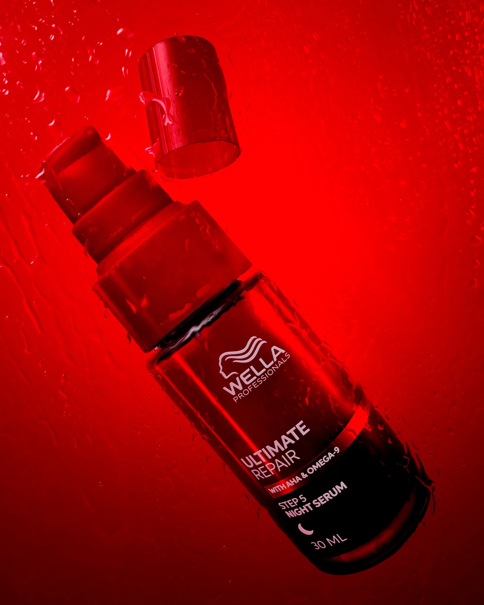 Image of Wella Ultimate Repair Night Serum over a red background
