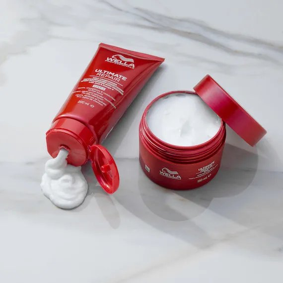 ULTIMATE REPAIR Conditioner and ULTIMATE REPAIR Mask on a white marble surface.