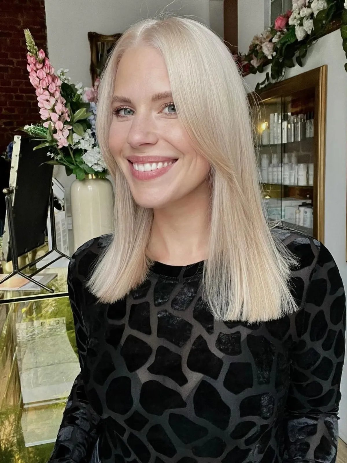 Model with mid-length, straight platinum blonde hair with a soft, neutral undertone.