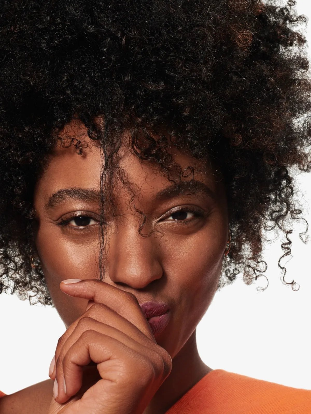 Model with short, dark, coily hair.