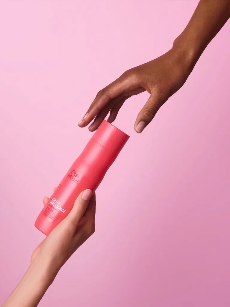 INVIGO Brilliance Shampoo Shampoo is passed from one model’s hand to another’s.
